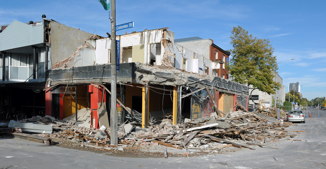 Earthquake performance of a seismically retrofitted building. This building had steel moment frames around the perimeter of the first level with plywood diaphragm strengthening under the second floor framing. Collapsed URM second level exterior walls and a collapse prevention performance level for level 1. Christchurch CBD, New Zealand.